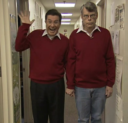 Stephen King and Colbert holding hands