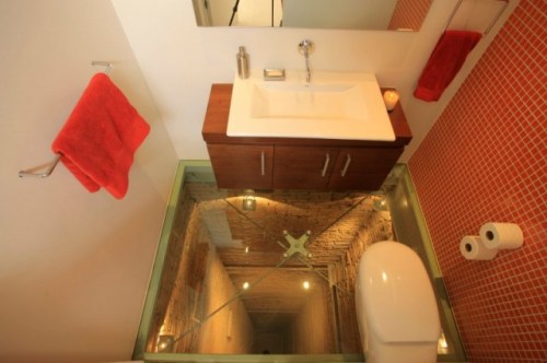 powder room and its glass floor set atop an unused 15 story lift shaft!