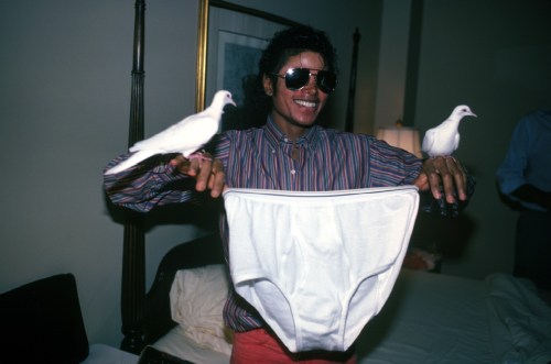 A picture of Michael Jackson holding a huge pair of underwear with doves on his wrists
