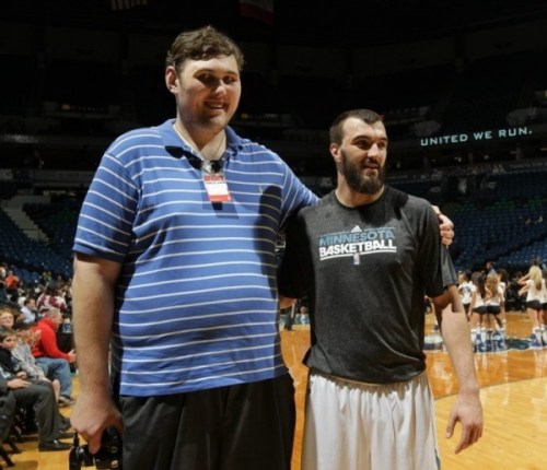 A picture of the tallest man in the world standing next to Nikola Pekovic of the Timberwolves.