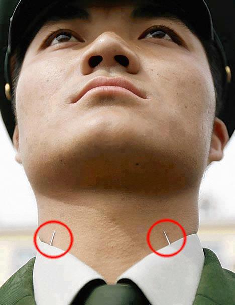 Chinese soldiers stick needles through uniform collars to maintain posture during military parades and formal events.