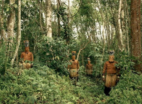 Guardians of the Forest: Deep in the Colombian Amazon, Yucuna indians stand dressed in traditional tribal attire for the Baile del Muñeco, or puppet dance, a celebration of the abundance of the Chontaduro fruit. While traditional indigenous customs are fast being lost throughout the Amazon jungle, here, far down the Caqueta river and few miles from the Brazilian border, traditions are still very much intact. The costumes are still made entirely from natural materials, predominantly tree bark, during this three day festival. (© Piers Calvert/National Geographic Photo Contest)