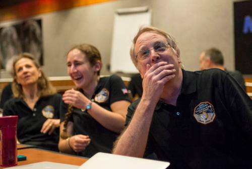 Members of the New Horizons science team react to seeing the spacecraft's last and sharpest image of Pluto before closest approach later in the day, Tuesday, July 14, 2015 at the Johns Hopkins University Applied Physics Laboratory (APL) in Laurel, Maryland. Photo Credit: (NASA/Bill Ingalls)